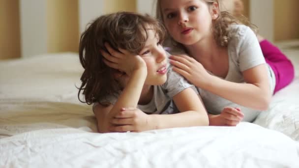 Little brother and sister lying on the bed. - Filmagem, Vídeo