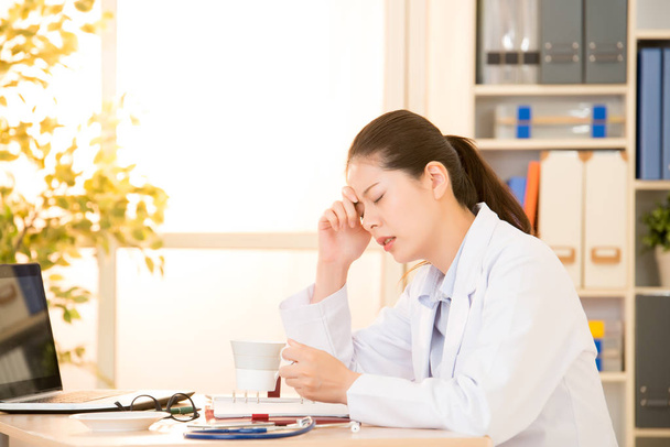 young doctor feel tired and headache - 写真・画像