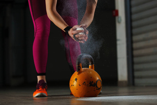 Young fit woman training by kettlebell. - Foto, immagini