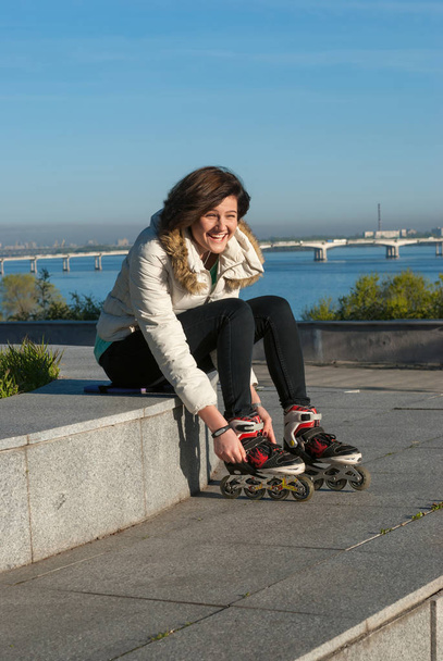 Joyful young woman is relaxing after rollerblading - Fotografie, Obrázek