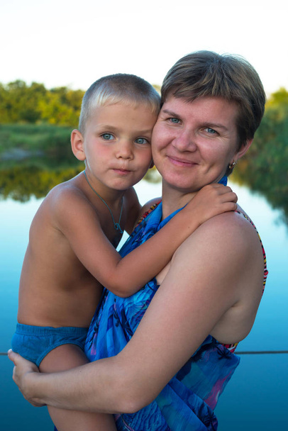 Portrait of a mom, who hugs his young son - Фото, зображення