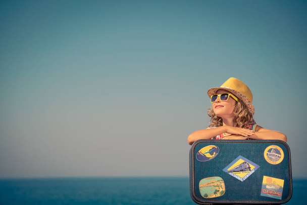 Child with vintage suitcase on summer vacation - Фото, изображение