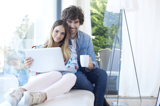 couple with laptop at home - Photo, Image