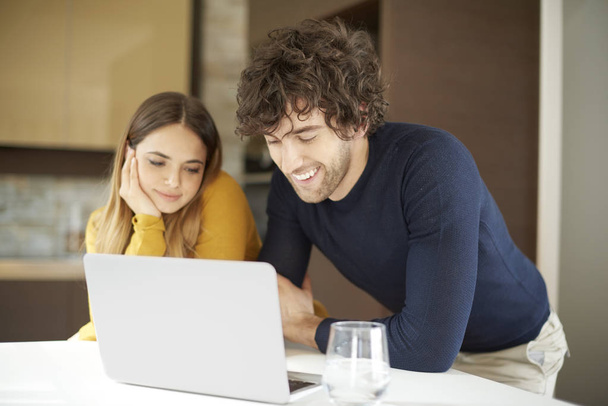 couple using laptop together at home - Photo, image