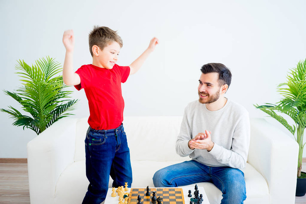 Father and son playing chess - Фото, изображение
