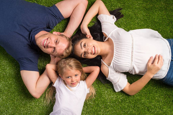 Family Laying In The Grass - Foto, Imagen