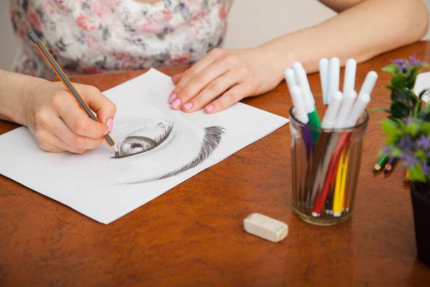 Closeup of drawing human eye at the desk - Fotó, kép