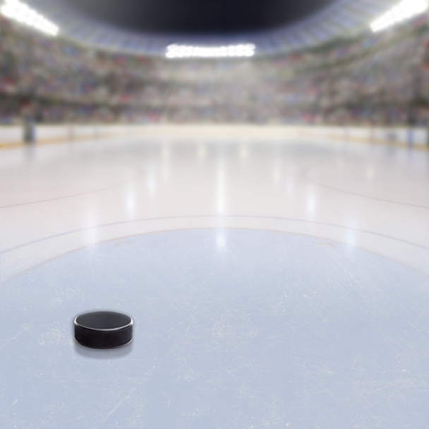 Hockey Puck on Ice of Crowded Arena - Photo, Image