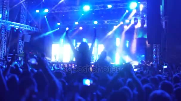 Thousands of music fans dancing, jumping at concert, enjoying band performance - Footage, Video