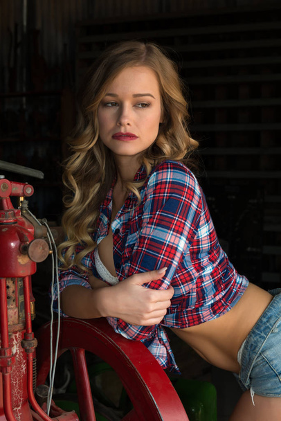 Blonde in plaid and jeans shorts - Foto, Imagen