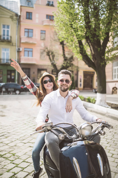 Couple in love riding a motorbike. Young riders enjoying themselves on trip. toned - Фото, изображение