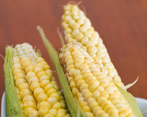 Three yellow corncobs that are used for different ecuadorian dishes - Fotoğraf, Görsel