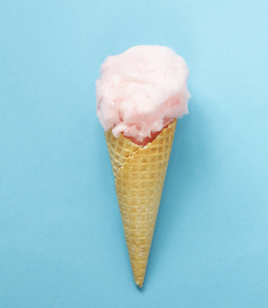 Sweet pink cotton candy in a waffle cone - Фото, зображення