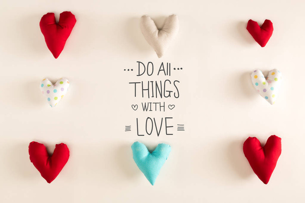 Do All Things With Love message with blue heart cushions - Valokuva, kuva