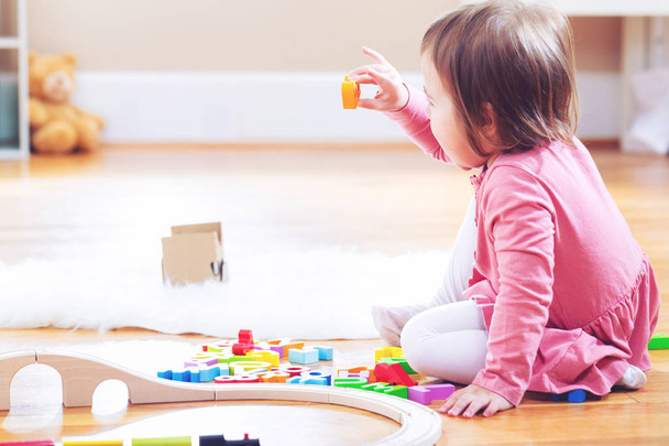 Happy toddler girl playing with toys - 写真・画像