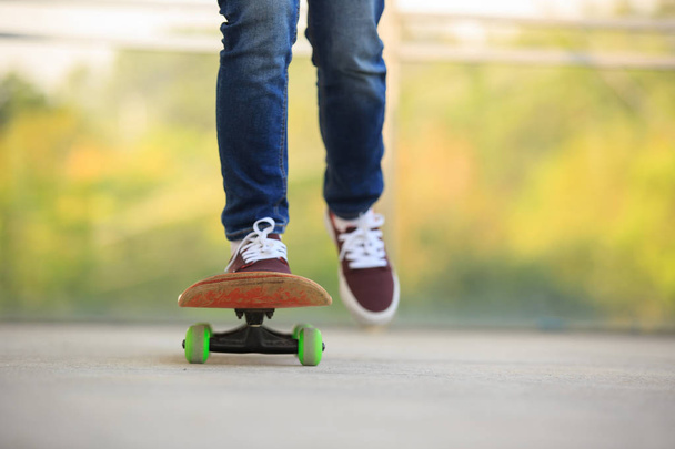 skateboarder legs practicing at skatepark - 写真・画像