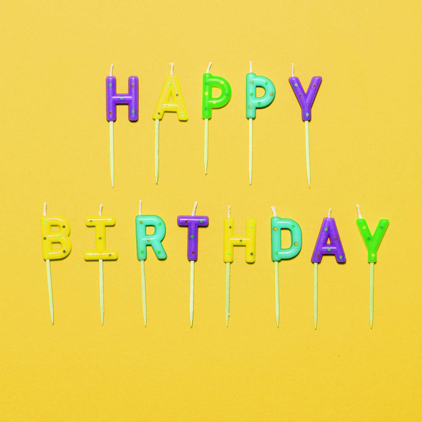 Happy Birthday flat lay party decorations on yellow background - Fotó, kép