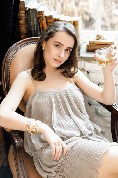 woman holding glass of whiskey - Fotó, kép
