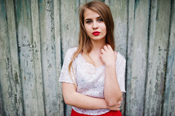 Portrait of beautiful girl with red lips against wooden backgrou - Photo, image