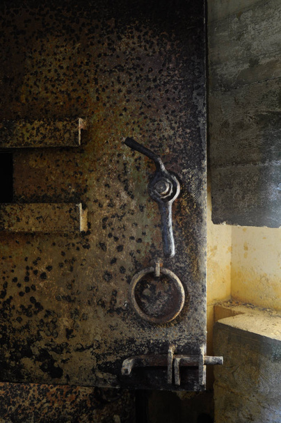 Rusty old heavy metal door in an underground bunker at Point du  - Photo, Image