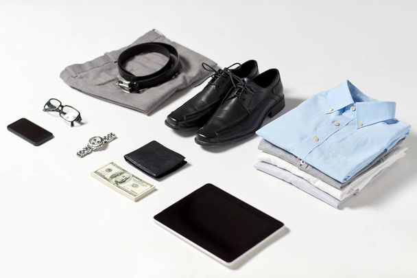 clothes, gadgets and business stuff on table - 写真・画像