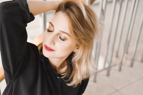 Girl young beautiful blonde hipster with red lips expressive eyes inside posing - Photo, image