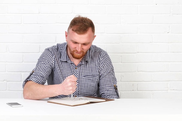 Businessman in casual cloth reading and signing document in office. Businessman hipster signs the document. Success, serious business. Emotional. Isolated. - Photo, Image