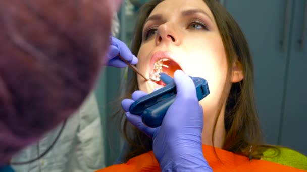 Closeup woman getting a dental treatment - Filmati, video