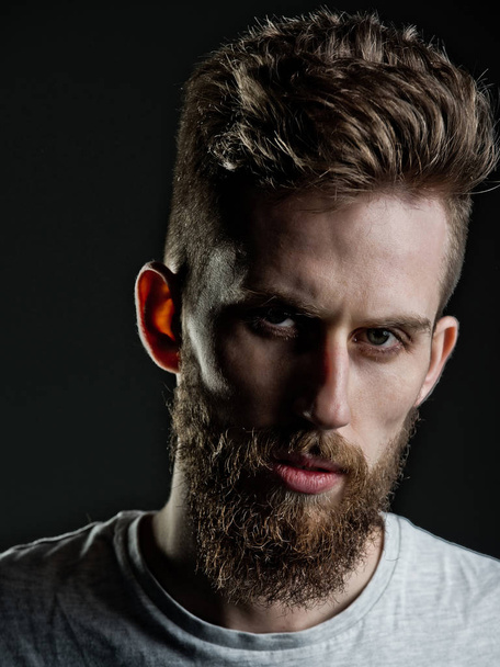 man, bearded young hipster has mustache on serious face - Foto, afbeelding