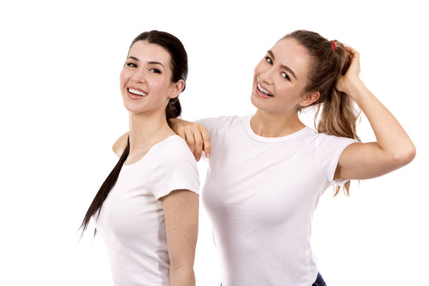 two female friends on white background - Фото, изображение