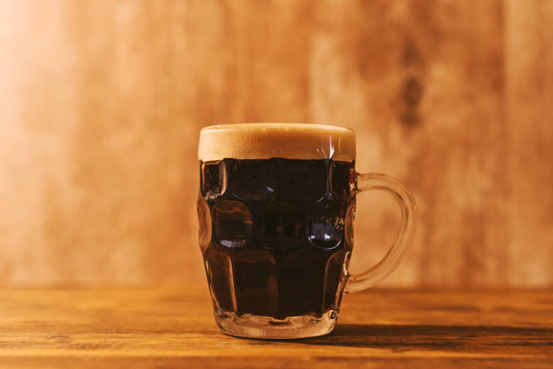 Dark craft beer in british dimpled glass pint mug - Photo, image