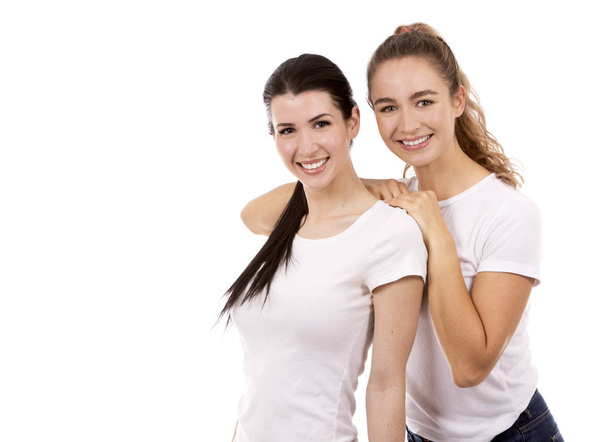 two female friends on white background - Foto, afbeelding