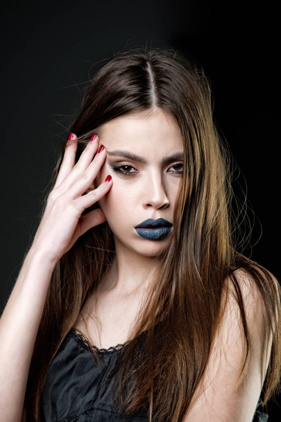 girl has fashionable lips makeup, long hair and red manicure - 写真・画像