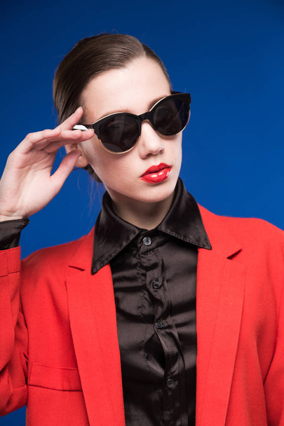girl in red jacket and sunglasses - 写真・画像