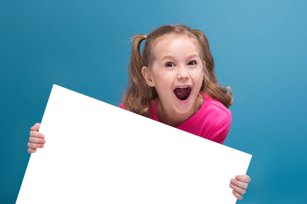 Little brunette girl with empty poster - Photo, image