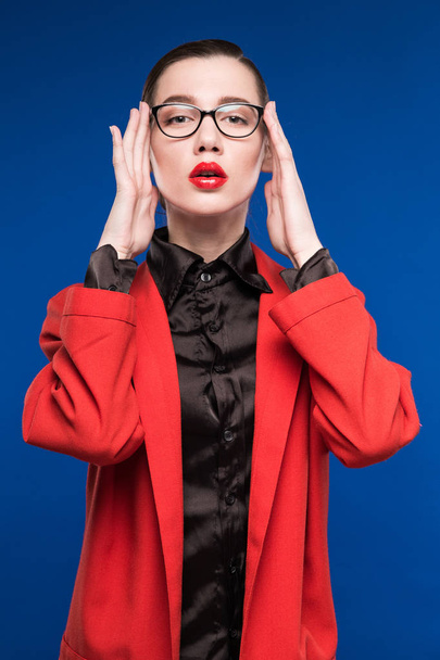 girl in red jacket and glasses - Фото, изображение