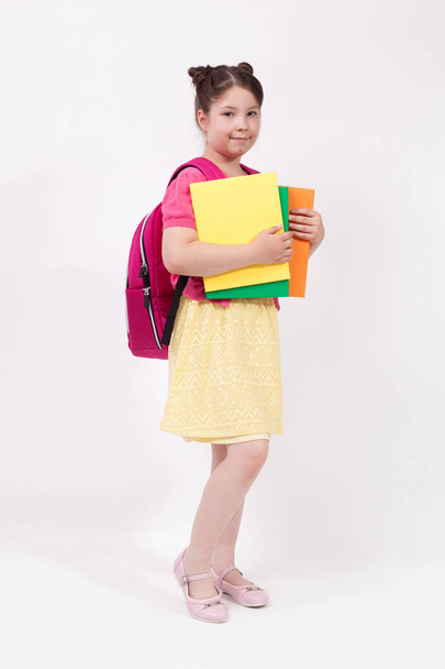 schoolgirl holding books - Фото, изображение