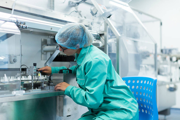 scientist is standing near machine at factory - Foto, imagen