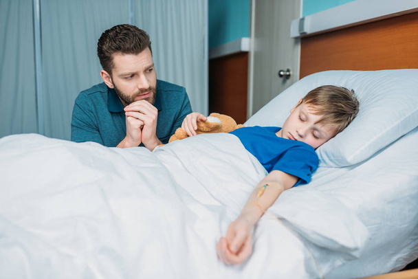 dad near son in hospital bed - Photo, Image