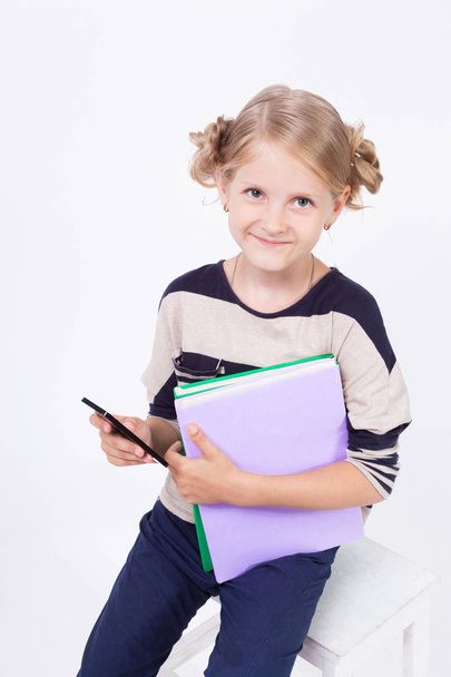 Schoolgirl with books and phone - Photo, Image