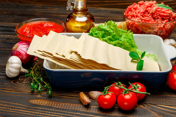 dried uncooked lasagna pasta sheets and ingridients - Fotografie, Obrázek