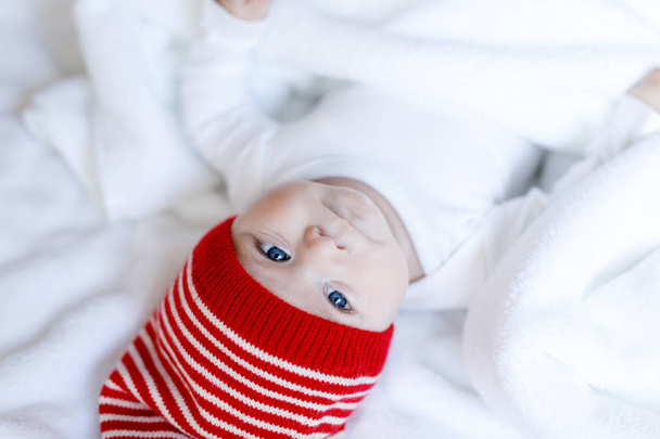 Cute adorable baby child with Christmas winter cap on white background - Zdjęcie, obraz