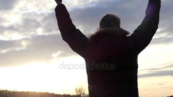 a Man Stands With His Back to us Near the Forest, he Raises His Hands up and Forms a Gesture With His Hands in the Shape of a Heart in Slow Motion - Footage, Video