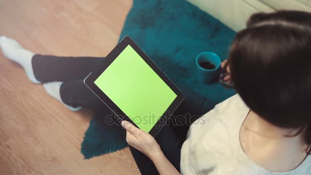 Woman Use Tablet Pc Sitting near Sofa - Materiał filmowy, wideo