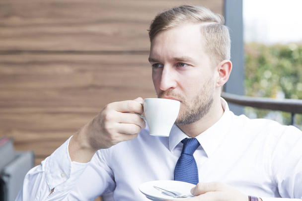 Modern businessman sitting at coffee shop  - Фото, зображення