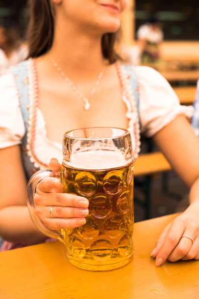 Beautiful young woman with beer stein at Munich Oktoberfest - Zdjęcie, obraz
