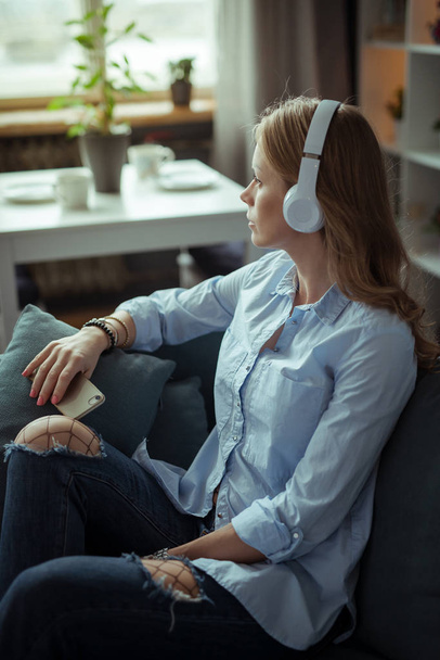 Beautiful young woman listening to the music - 写真・画像