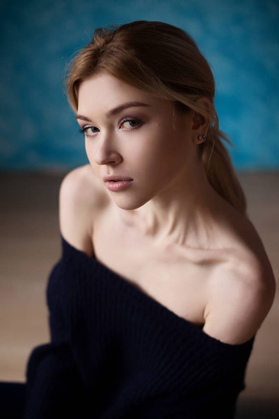 Portrait of blond girl in blue sweater  - Valokuva, kuva