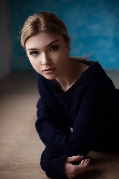 Portrait of blond girl in blue sweater  - Фото, изображение