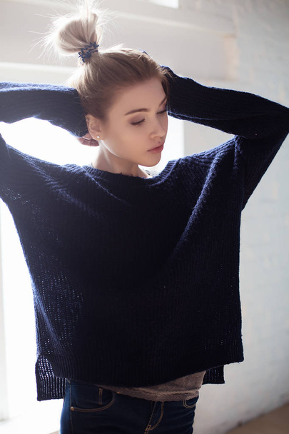 Portrait of blond girl in blue sweater  - Фото, изображение